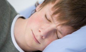A teenage boy sleeping